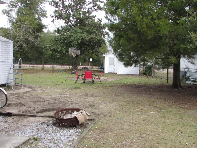 a view of a yard with a tree