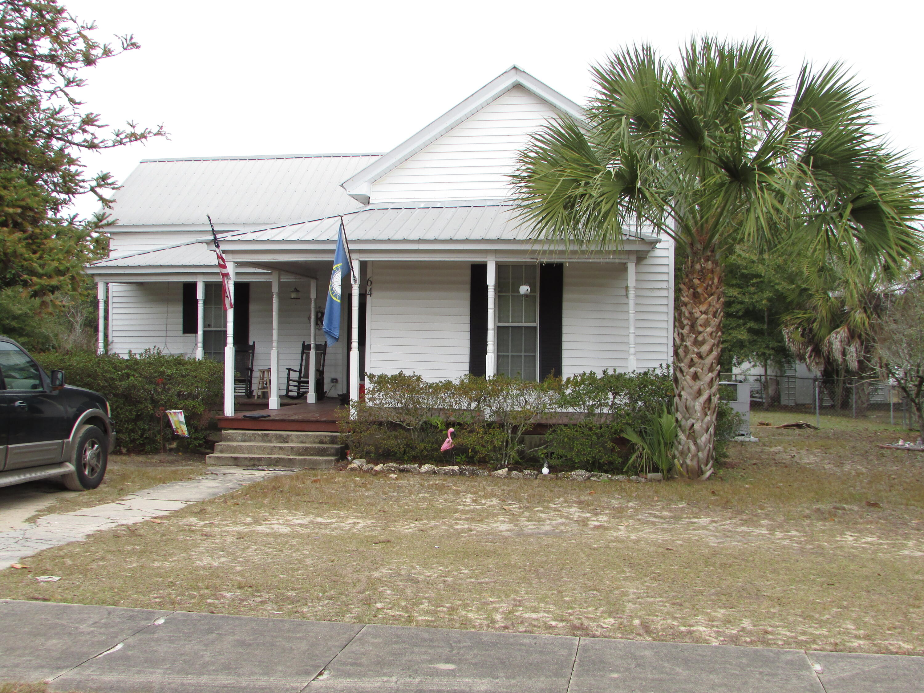 64 Live Oak Avenue West DeFuniak Springs, FL 32435 - Photo 15 of 20 a view of a house with backyard and sitting area