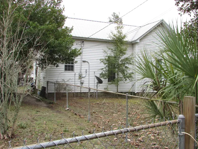 a backyard of a house with table and chairs