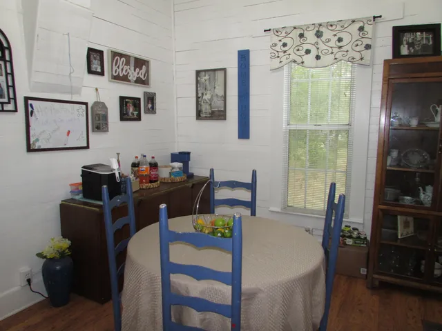 a view of a dining room with furniture and window