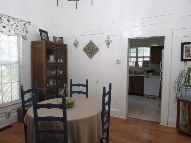 a view of a dining room with furniture and wooden floor