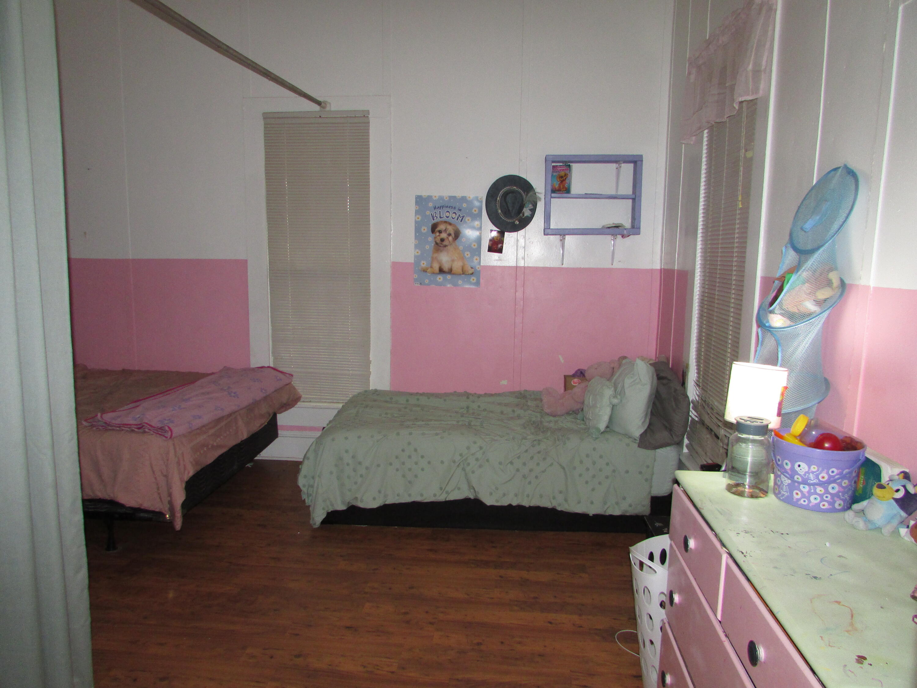 64 Live Oak Avenue West DeFuniak Springs, FL 32435 - Photo 5 of 20 a bedroom with a bed and a dresser next to it