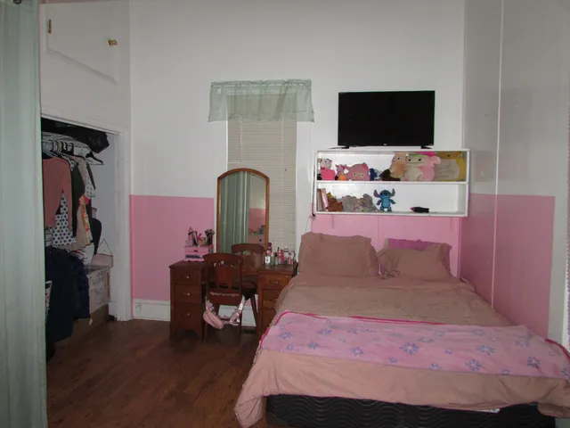 a bedroom with a bed and a flat screen tv