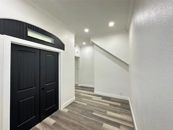 a view of a hallway with wooden floor