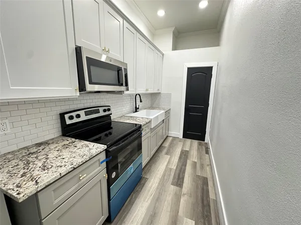 a kitchen with a stove and a microwave