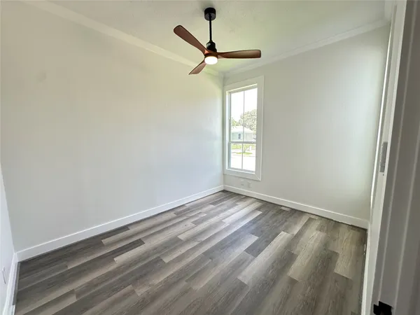 a view of room with window and ceiling fan