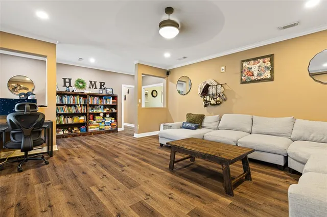 a living room with furniture a rug and a flat screen tv