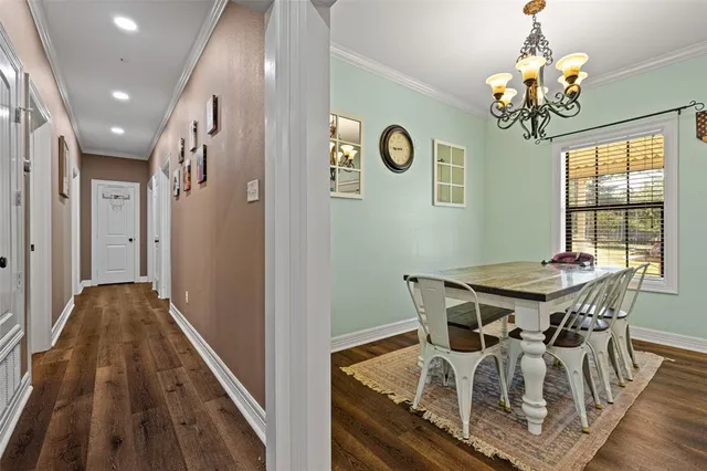 a view of a dining room with furniture and chandelier