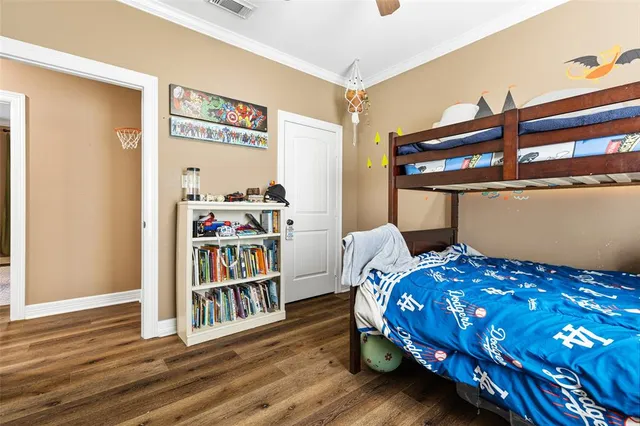 a bedroom with a bed and a book shelf