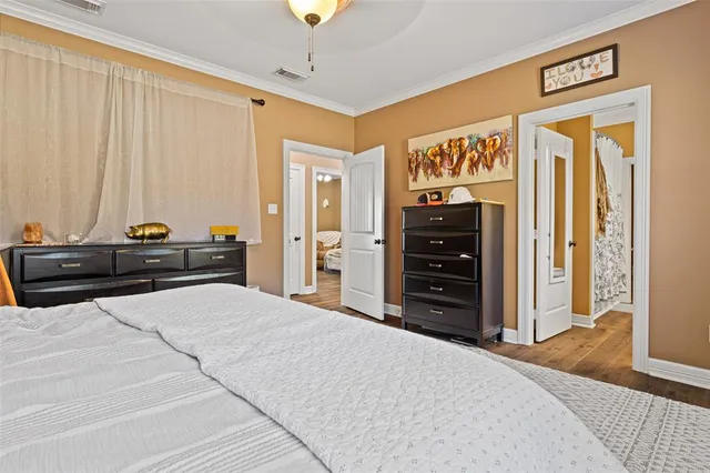 a bedroom with a bed and a television