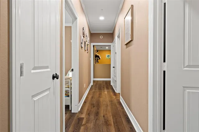 a view of hallway with wooden floor
