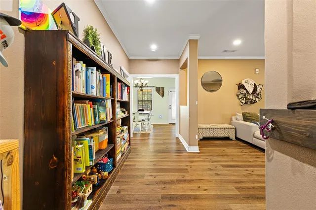 a living room with lots of furniture and a book shelf