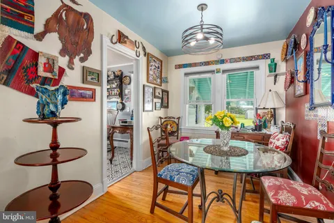 a kitchen with stainless steel appliances granite countertop a sink a stove a refrigerator cabinets and dining table