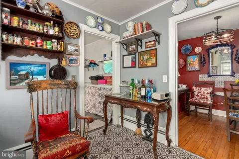 a bedroom with a bed a flat screen tv and dresser
