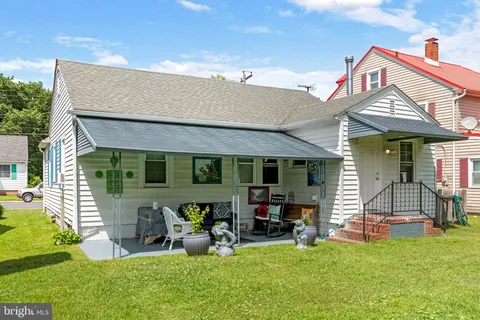 a front view of house with yard and outdoor seating