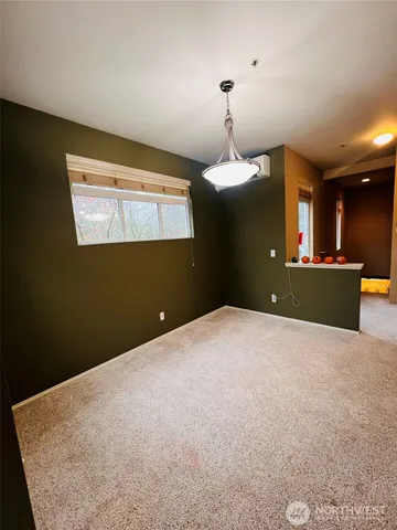 a view of an empty room with kitchen