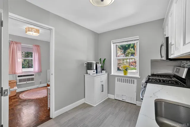 a kitchen with a refrigerator a stove a microwave and wooden floor