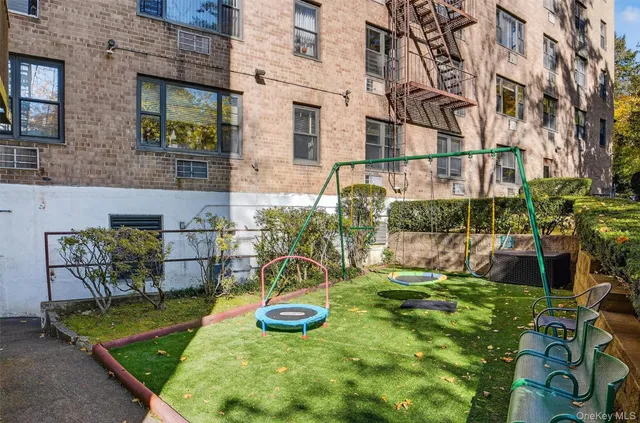 a view of a park with iron fence