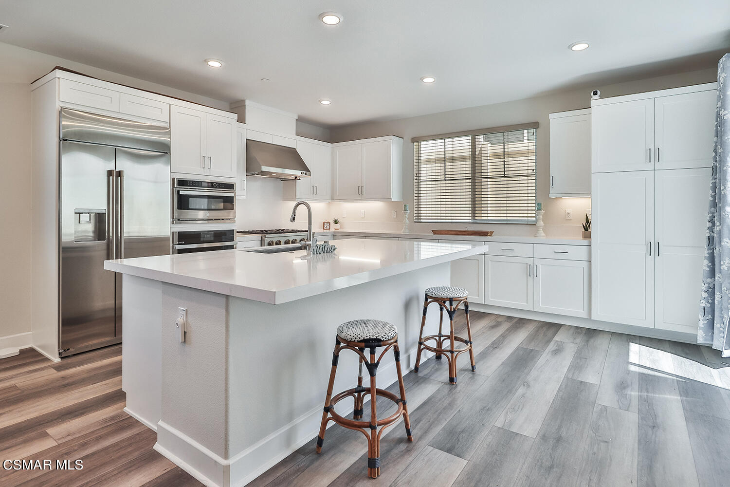 3068 Harrison Lane Simi Valley, CA 93065 - Photo 12 of 48 a kitchen with stainless steel appliances granite countertop a stove top oven a sink refrigerator and cabinets