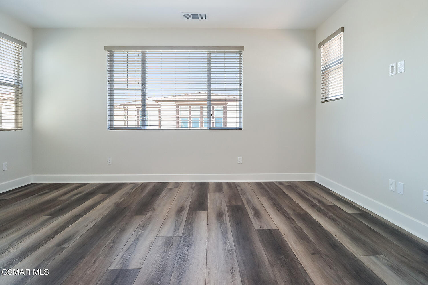 3068 Harrison Lane Simi Valley, CA 93065 - Photo 24 of 48 an empty room with wooden floor and windows