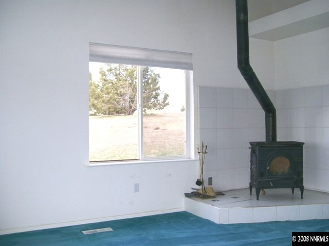 110 Alpha Butte Road Reno, NV 89508 - Photo 5 of 9 a room with a fireplace and windows