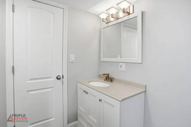 a bathroom with a sink and a mirror