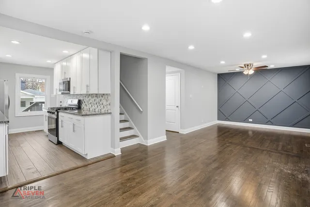 a view of kitchen with cabinets and wooden floor
