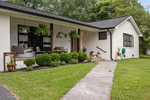a front view of a house with garden