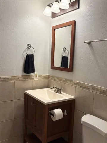 a bathroom with a toilet a sink and bathtub