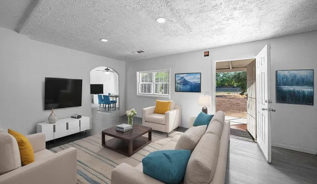 a living room with furniture and a flat screen tv