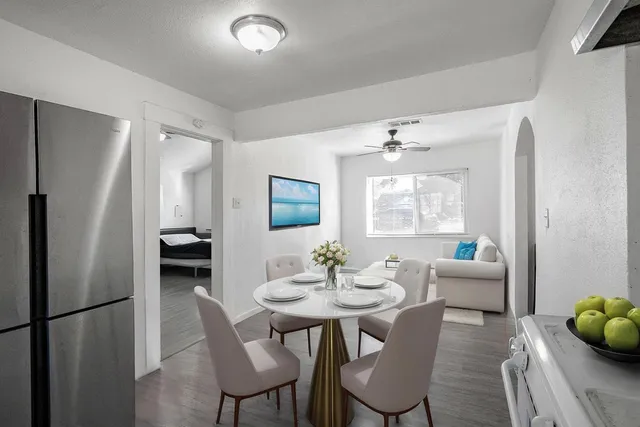 a view of a dining room with furniture and window