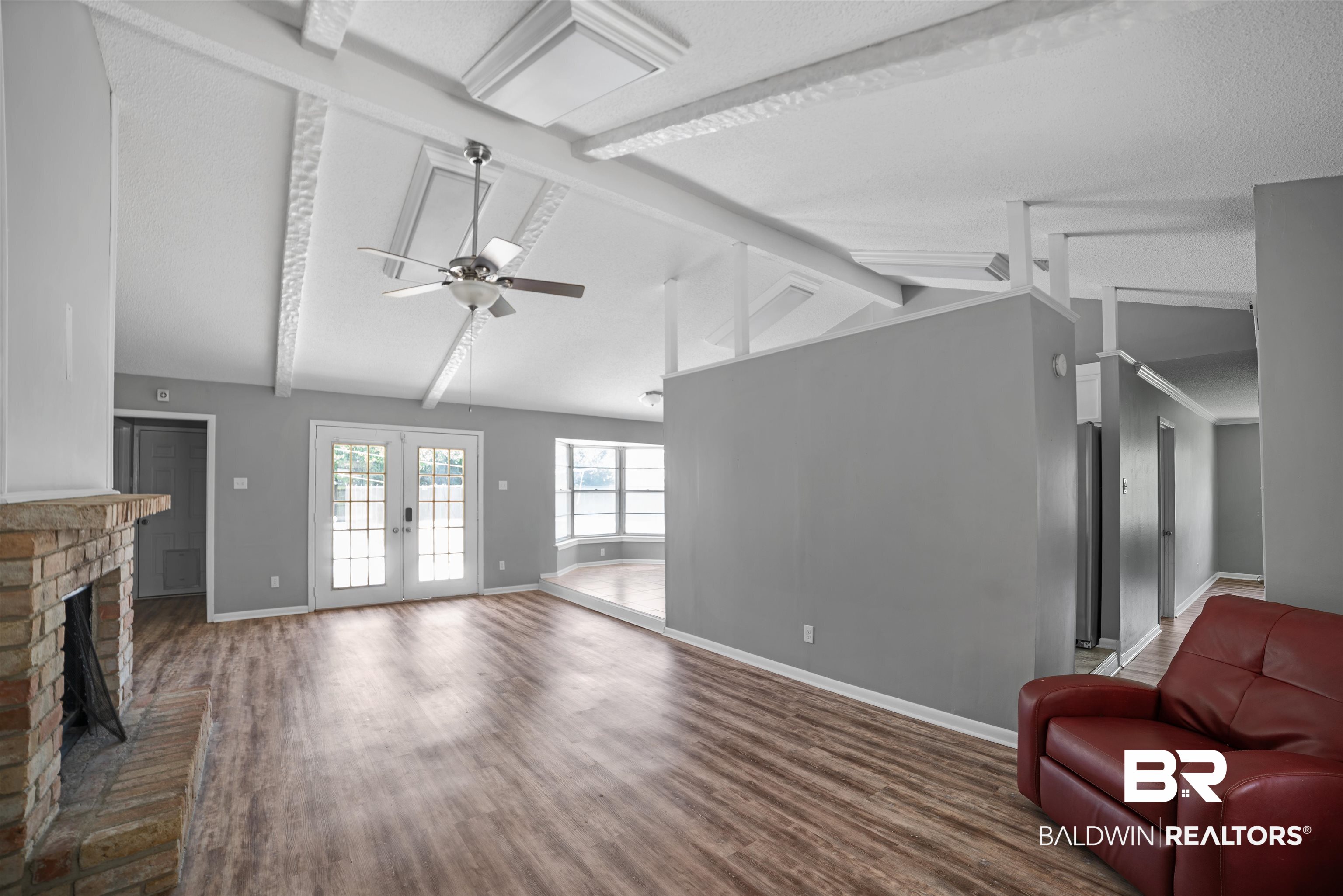 804 Regents Drive West Mobile, AL 36609 - Photo 6 of 35 Living area with ceiling fan, wood finished floors, a fireplace, a textured ceiling, and french doors