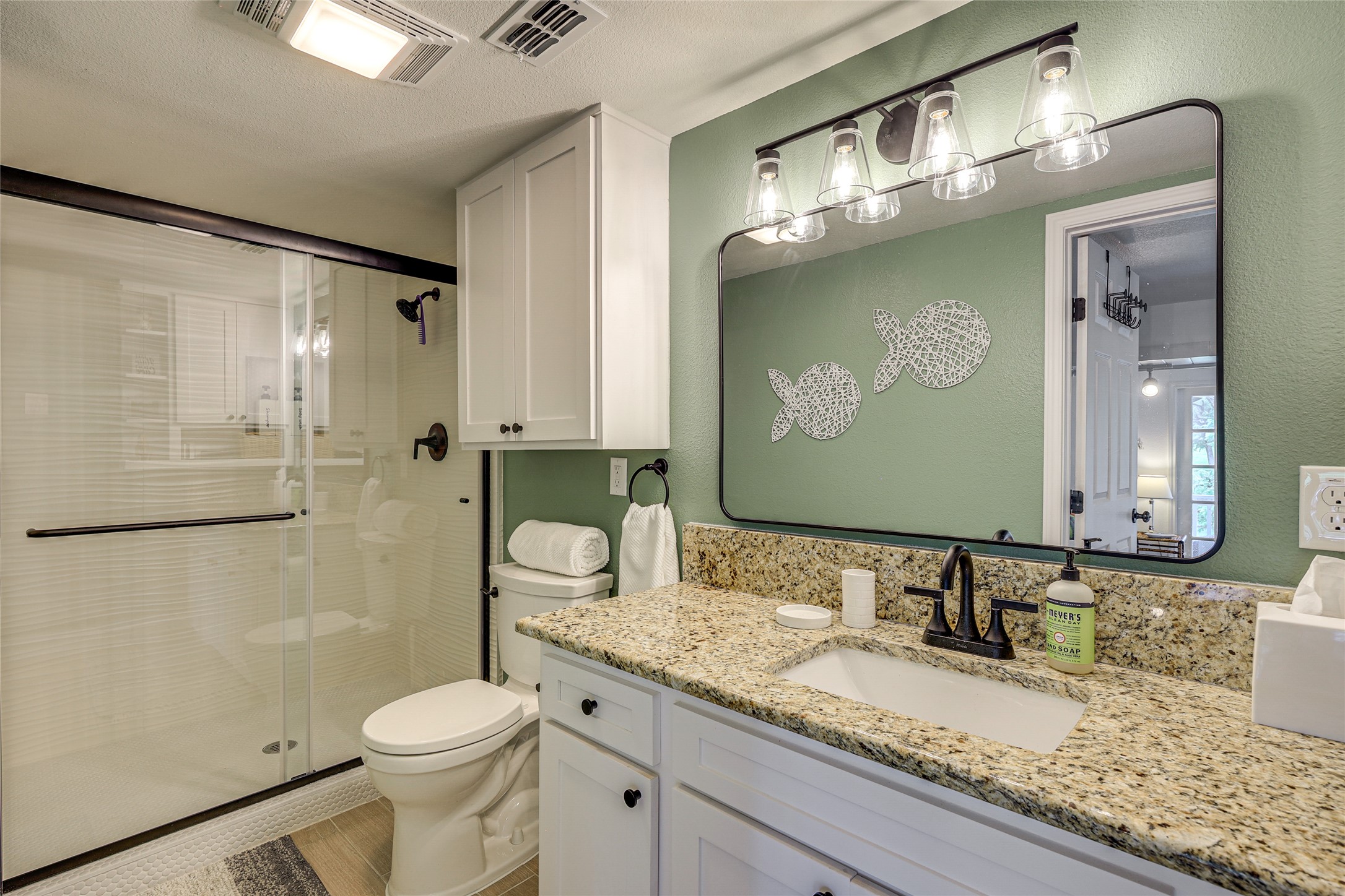 279 Waltons Way Seguin, TX 78155 - Photo 13 of 40 a bathroom with a granite countertop sink a mirror and a toilet