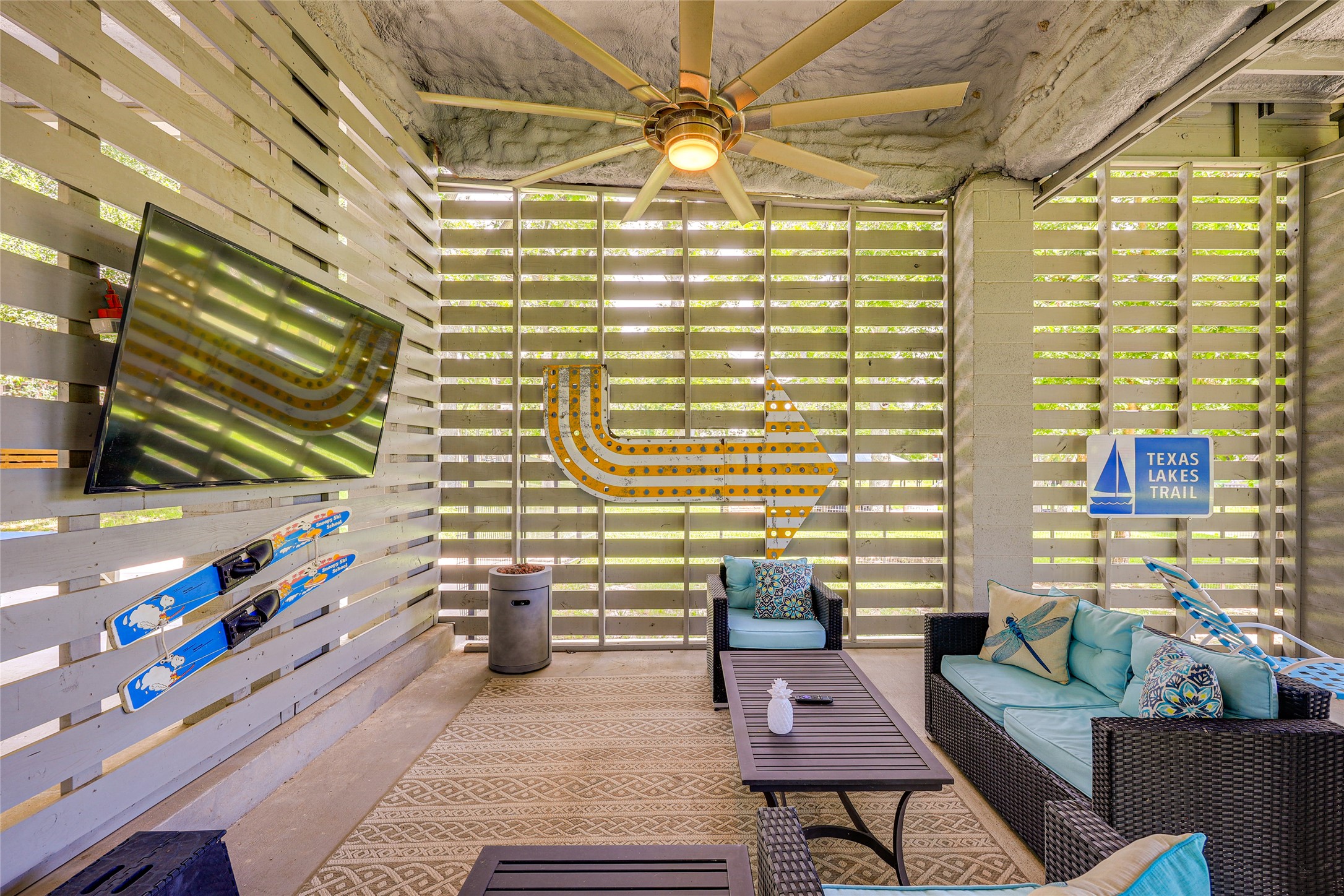 279 Waltons Way Seguin, TX 78155 - Photo 19 of 40 Enjoy watching the game on the TV under huge ceiling fans. Slatted siding provides air circulation, privacy and rain protection.