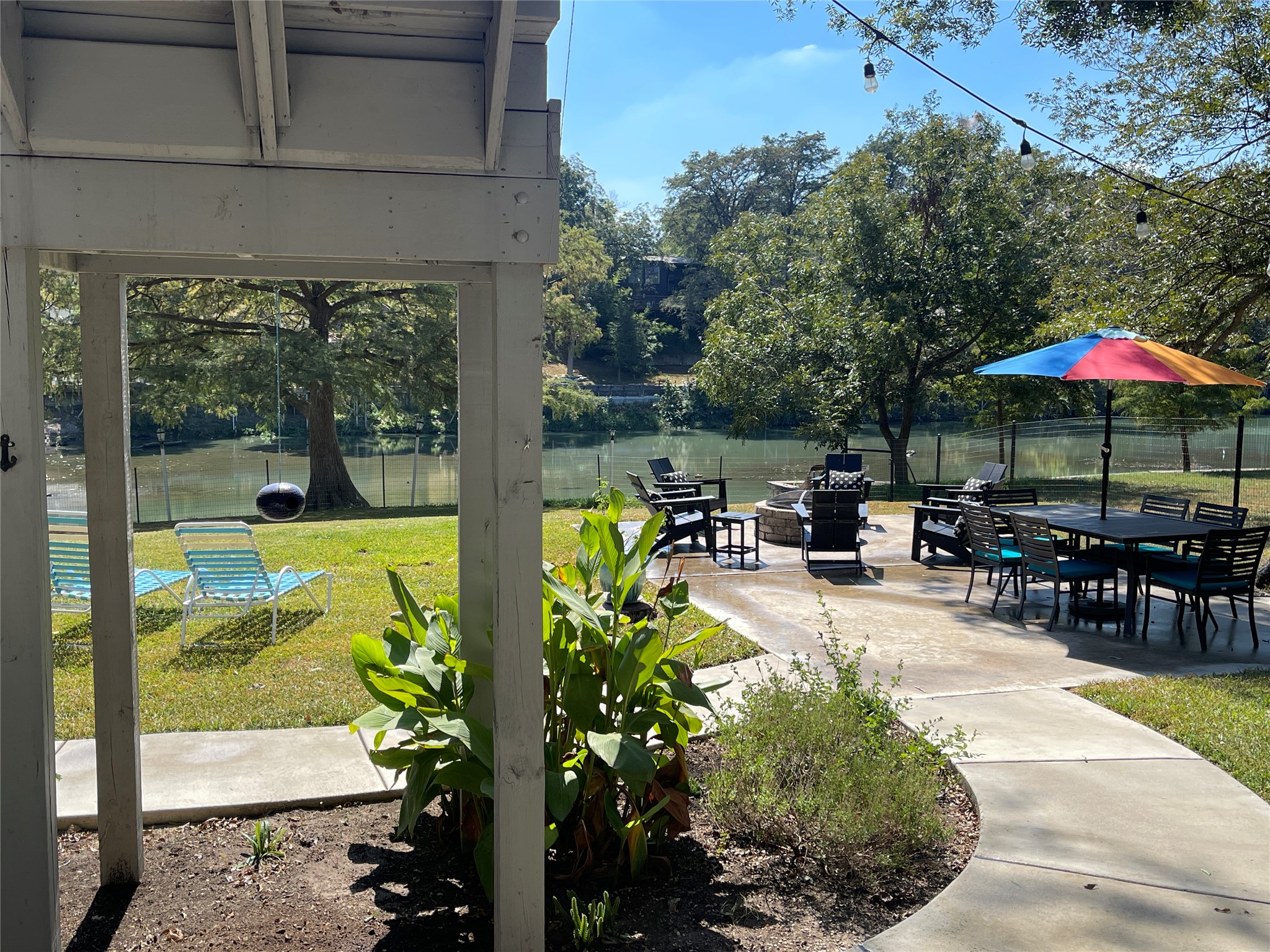 279 Waltons Way Seguin, TX 78155 - Photo 2 of 40 View of Lake McQueeney, firepit and patio area, and perennial garden.
