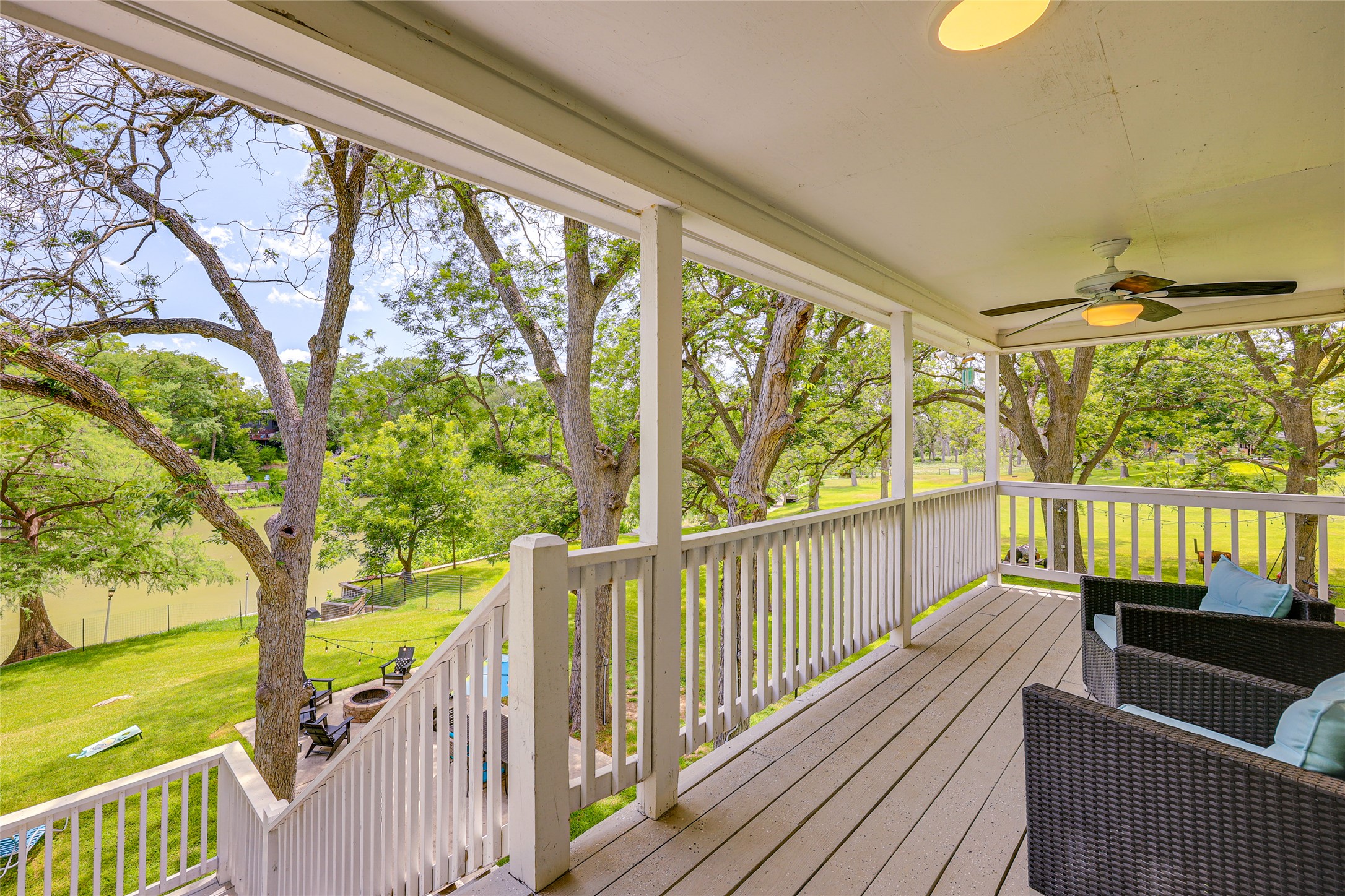 279 Waltons Way Seguin, TX 78155 - Photo 32 of 40 Back balcony overlooking lake spans the width of the home. Exterior walk-in closet to store floats and cushions. Updated light fixtures.