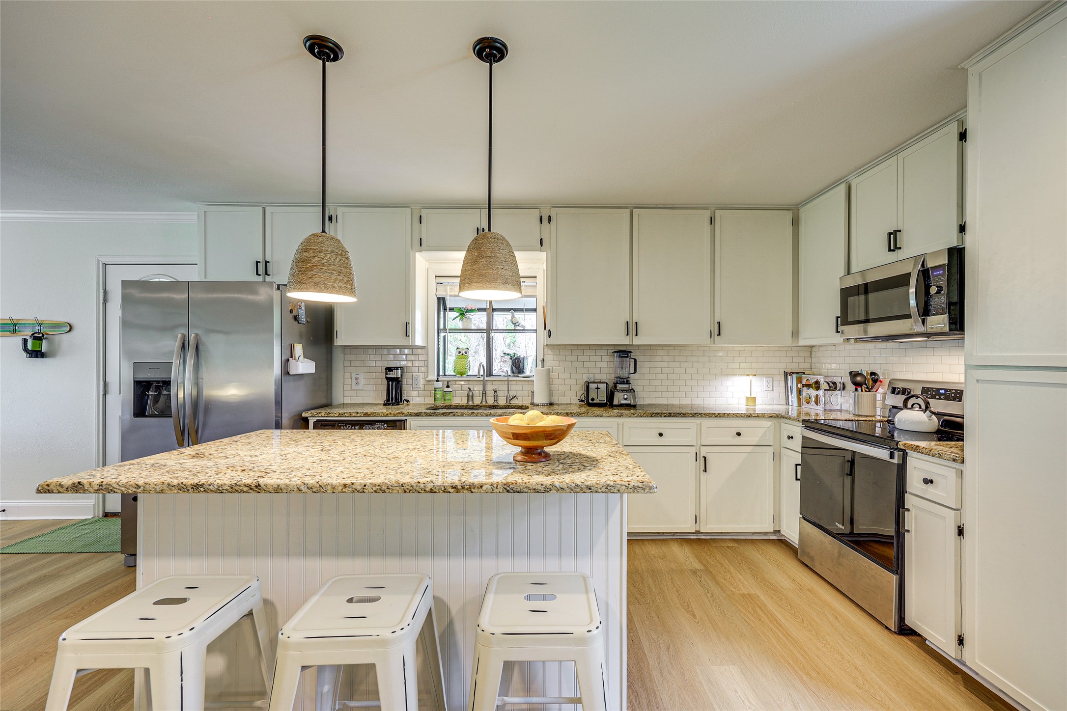 279 Waltons Way Seguin, TX 78155 - Photo 8 of 40 a kitchen with stainless steel appliances granite countertop a sink stove and refrigerator