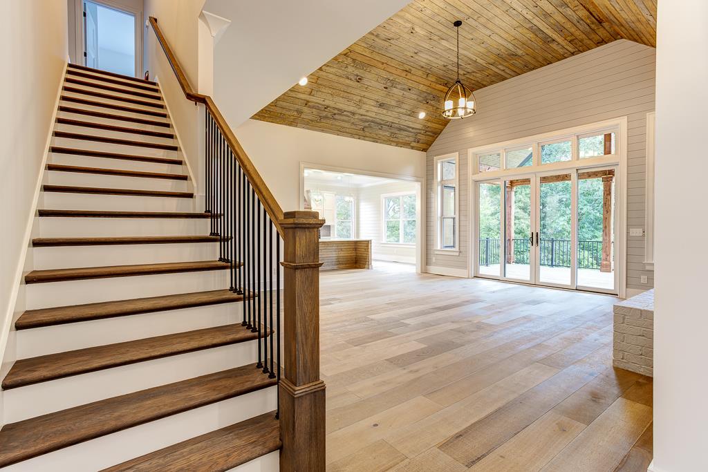 538 Ridgecrest Lane Lebanon, TN 37087 - Photo 30 of 30 Impressive entry coming off foyer showcasing the hardwood stairs and open floorplan with stained vaulted ceilings in the great room, lots of windows for natural light and shiplap walls to accent.