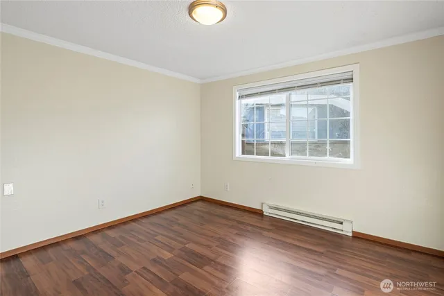a view of a room with wooden floor and windows