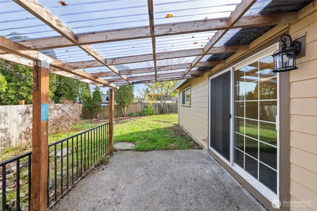 a view of a backyard with wooden fence
