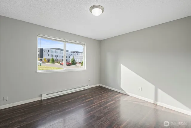 a view of an empty room with wooden floor