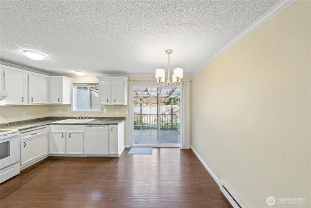 a open kitchen with granite countertop cabinets and wooden floor
