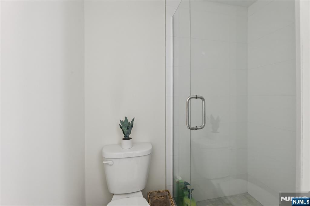 45-47 Franklin Street Tenafly, NJ 07670 - Photo 22 of 41 a bathroom with a granite countertop toilet and a shower