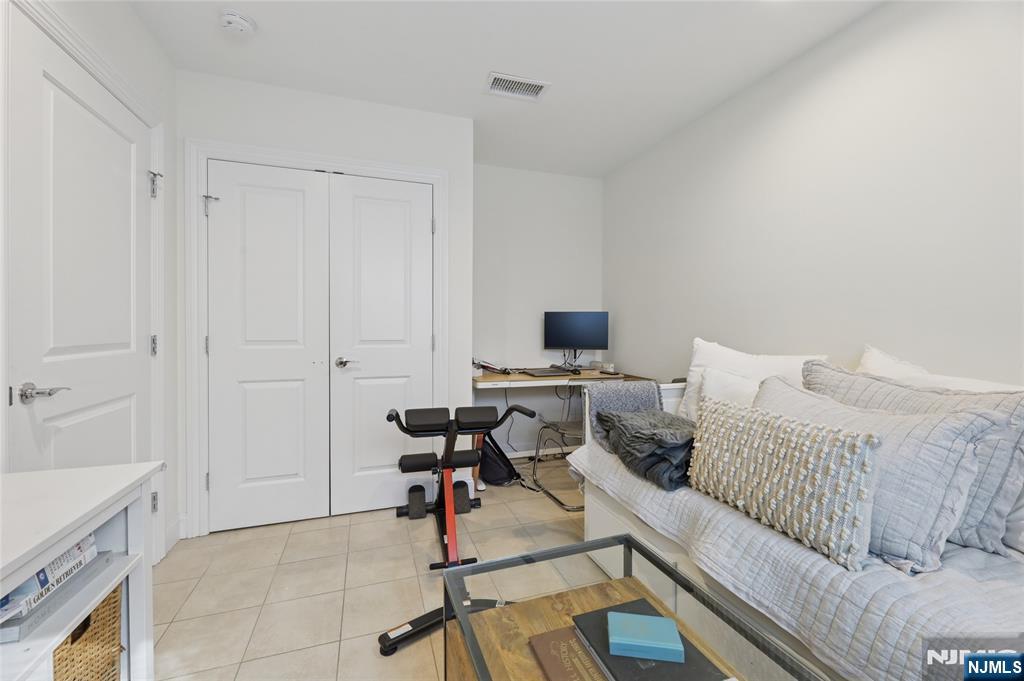45-47 Franklin Street Tenafly, NJ 07670 - Photo 25 of 41 a living room with furniture and a flat screen tv