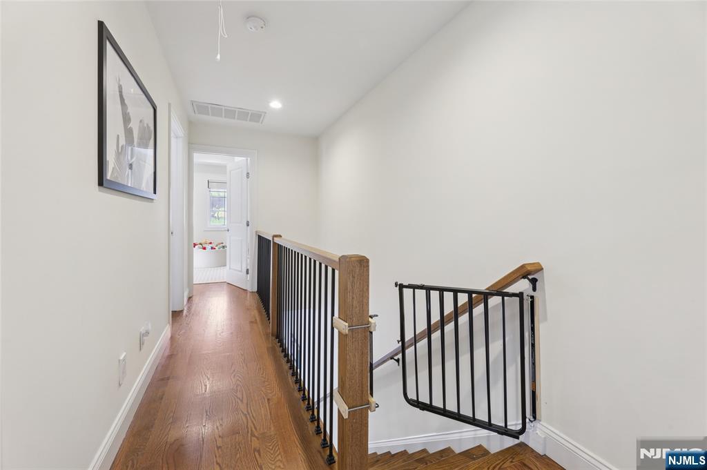 45-47 Franklin Street Tenafly, NJ 07670 - Photo 30 of 41 a view of a hallway with wooden floor and stairs