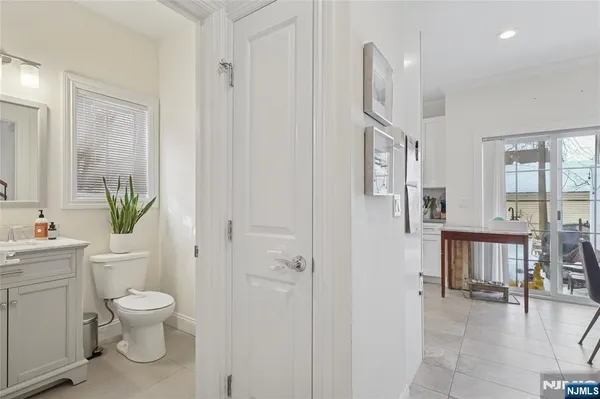a bathroom with a toilet a sink and a large mirror