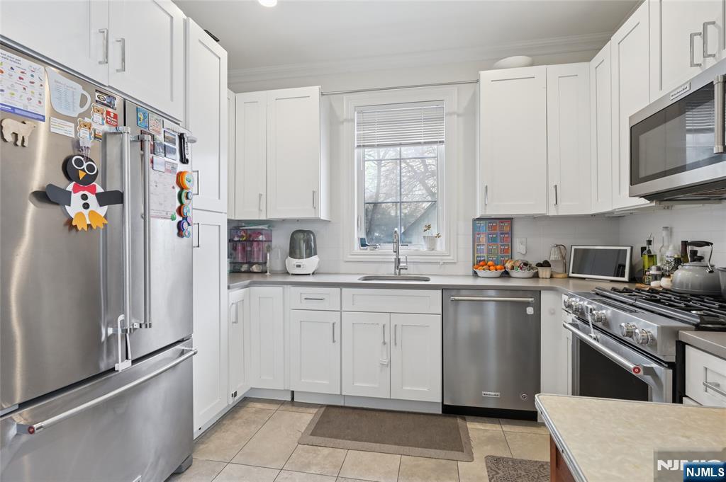 45-47 Franklin Street Tenafly, NJ 07670 - Photo 10 of 41 a kitchen with stainless steel appliances granite countertop a refrigerator sink and stove