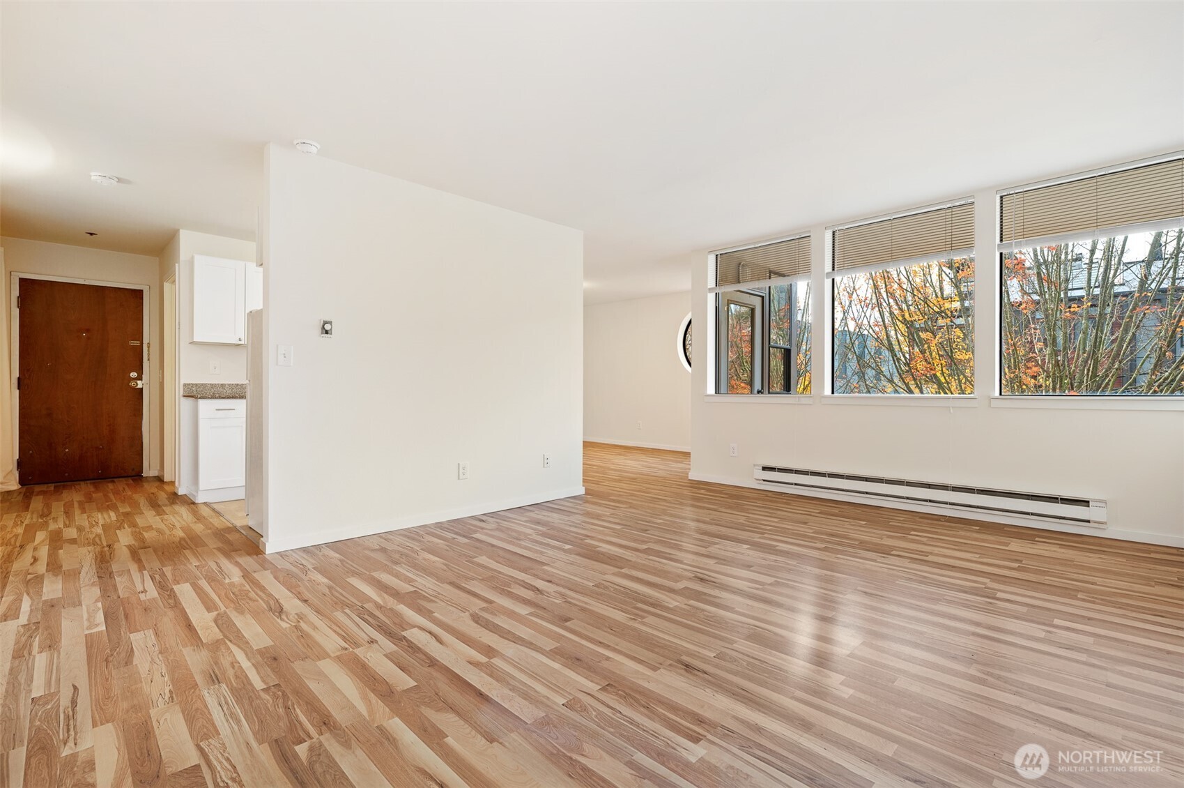 802 North 43rd Street Seattle, WA 98103 - Photo 14 of 18 a view of an empty room with wooden floor and a window