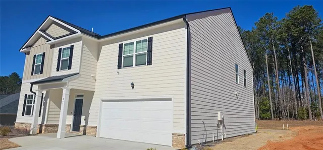 a view of a house with a backyard
