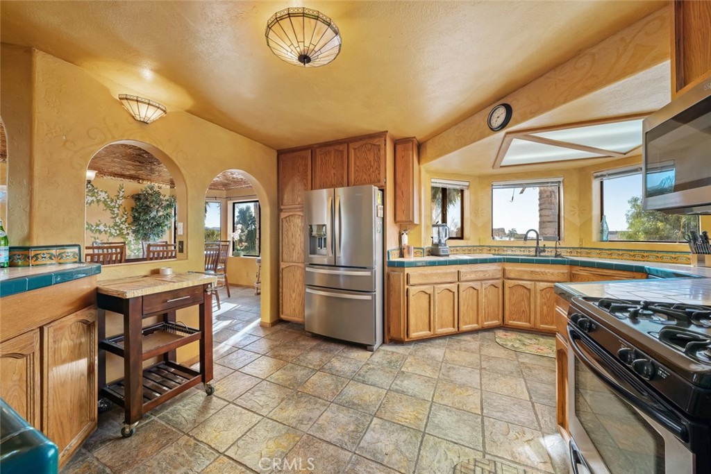 330 East Ormonde Road Arroyo Grande, CA 93420 - Photo 11 of 56 a kitchen with stainless steel appliances granite countertop a stove a sink dishwasher and a refrigerator